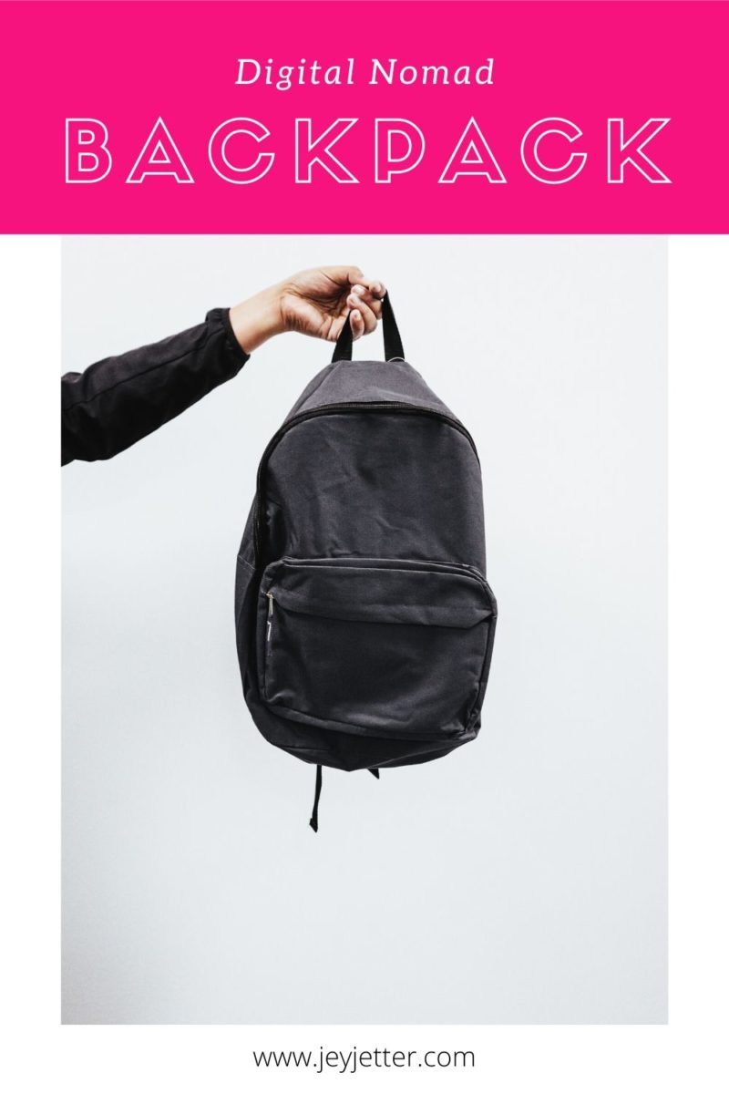 Hand holding black backpack, pin for Pinterest