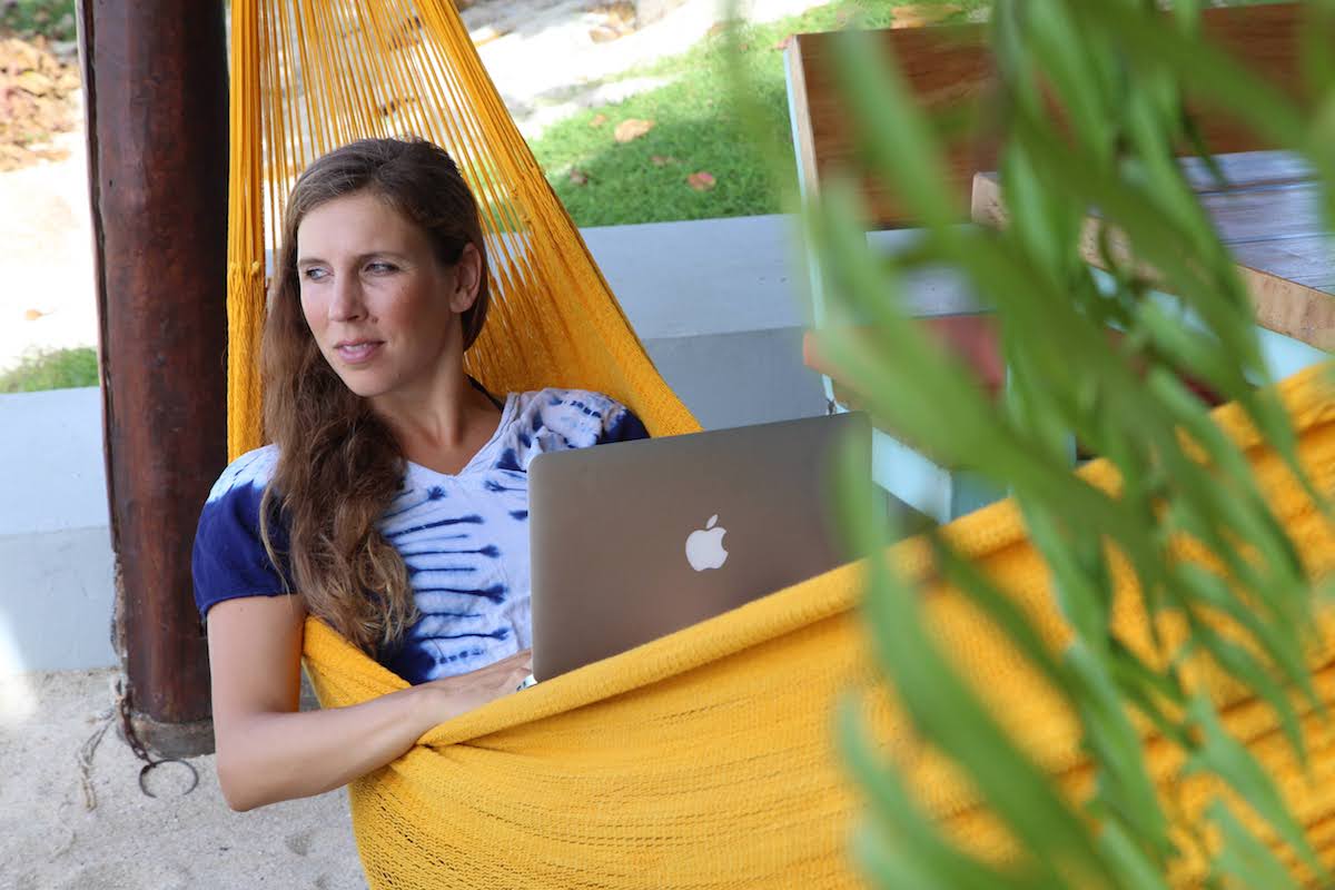 Top paying digital nomad jobs can be done, even from a hammock like this woman does.